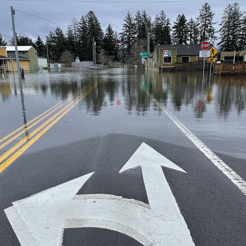 Highway101 and North Fork Road intersection in downtown Nehalem During a King Tide. Photo by @PASCOPDX, 2022